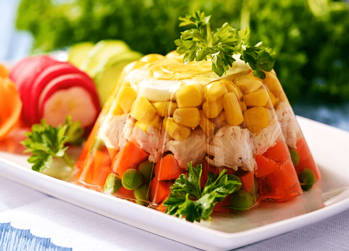Chicken in aspic with vegetables, eggs and fresh herbs