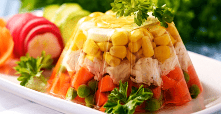Chicken in aspic with vegetables, eggs and fresh herbs