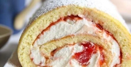 Soft vanilla chiffon rolled and filled with whipped cream and jam